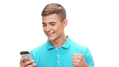 Young Man Celebrates Success on Smartphone