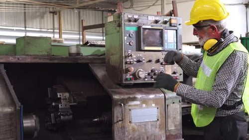 Senior Factory Worker Teach How to Use Machine Equipment in the Factory Workshop