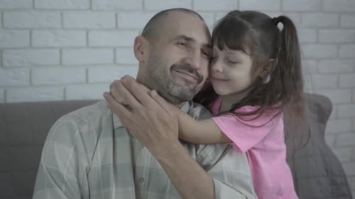Father and Child Embracing Affectionately Indoors