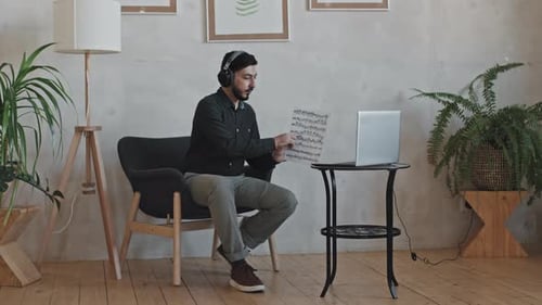 Man Discussing Music Online in Bright Room