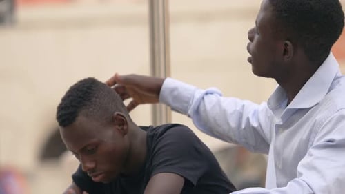 Family support. sad young black man is comforted by his old brother- outdoor