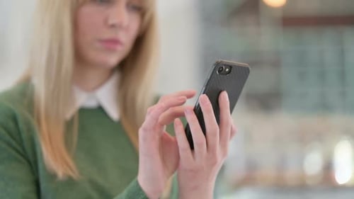 Close Up of Hands of Young Woman Using Smartphone