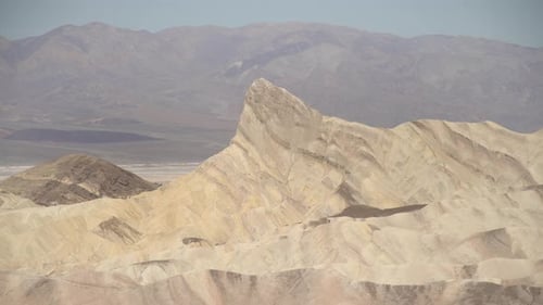 Pan right of dunes and peaks in Death Valley