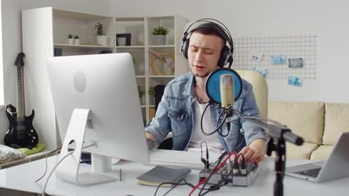 Man Recording Audio in Home Music Studio
