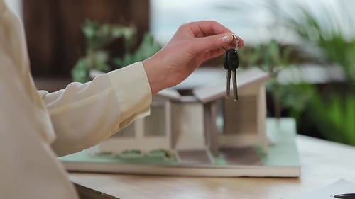 Business, Real Estate, Deal and People Concept - Man Giving House Keys To Woman at Office