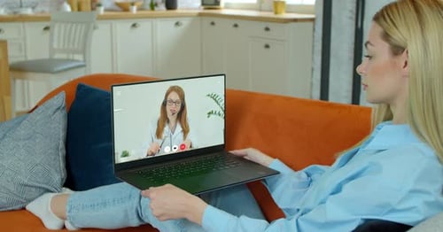 Woman Having Telemedicine Appointment on Laptop at Home