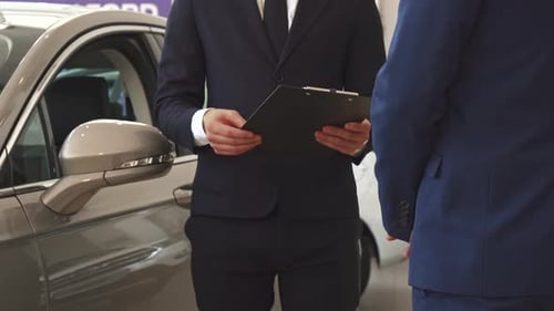 Men Shake Hands at the Dealership