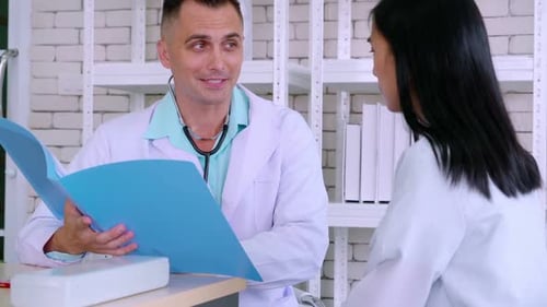 Doctor in Professional Uniform Examining Patient at Hospital