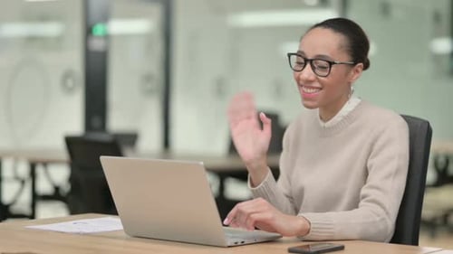 Woman on Laptop in Office Attending Video Conference