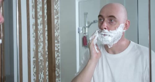 Middleaged is Shaving Using Disposable Razor in Bathroom Closeup Side View