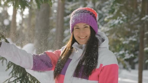 Woman Enjoying Winter Day in Snow-Covered Forest