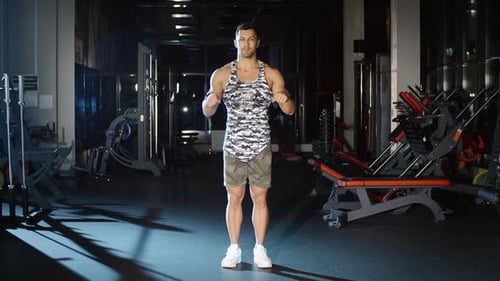 Athletic Man Works out Stretches Wrists Rotates Torso Trains Low Back