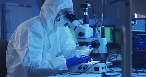 Scientist Examining Sample with a Microscope