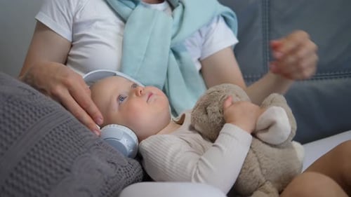 Baby Listening to Music with Stuffed Animal