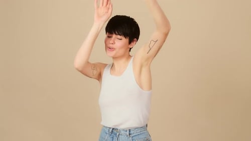 Joyful Woman Dancing Happily in Front of Backdrop