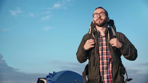 Young Adult Man with Backpack Outside