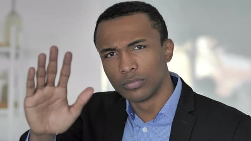 Man Gesturing Stop in Business Setting