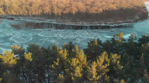 Wild River Valley with Frozen Water in a Wooded Area