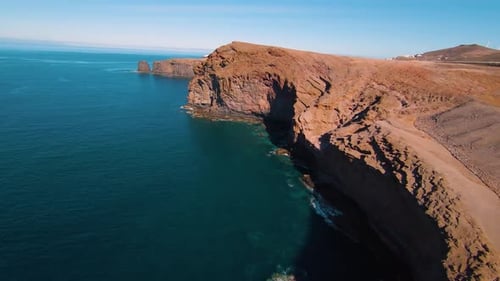 Drone flying over some cliffs and the sea, sunny day in Gran Canaria, 4K