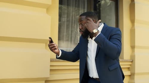 Young Adult in Suit Engaged in Video Call