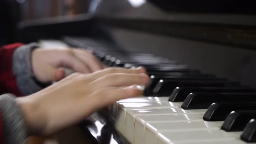 Child Plays Piano Close-Up