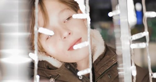 Boy Gazing at Christmas Lights in the Night