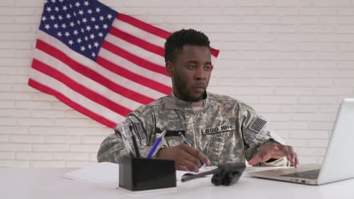 American Soldier Working with Laptop in Headquarter Building