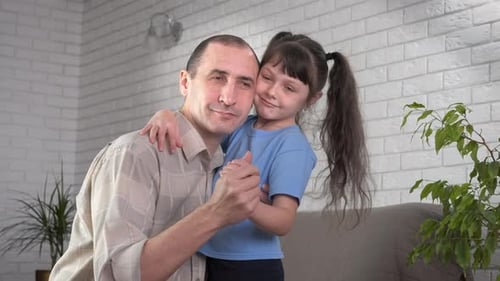 Father Dancing with his Daughter in Living Room