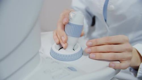 Close Up of Hands of Doctor Working on Device in Medic Clinic