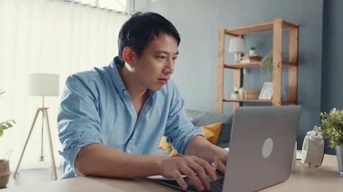 Young Adult Working at Laptop from Home