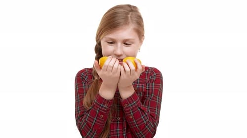 Girl Playing with Orange Halves on White Background
