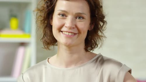 Smiling Woman Holding Easter Egg Bowl Indoors