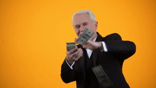Happy Senior Man Scattering Money in Celebration