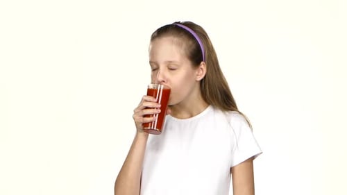 Happy Child Drinks Red Juice on White Background