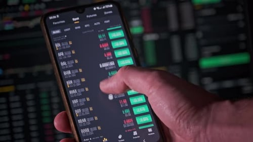 Hand Uses Smartphone to Trade Cryptocurrency