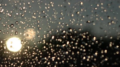 Sun Shining Through Water Droplets on Window