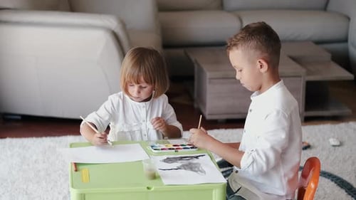 Boy and Girl Painting at Home Together