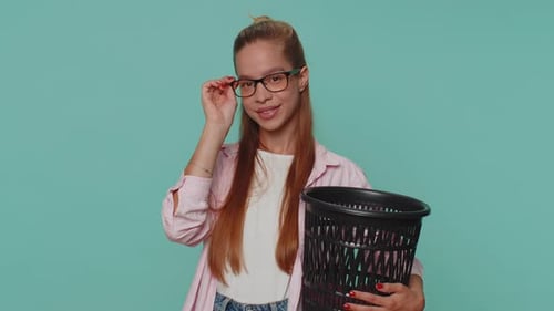 Smiling Woman Throws Away Items in Trash Can