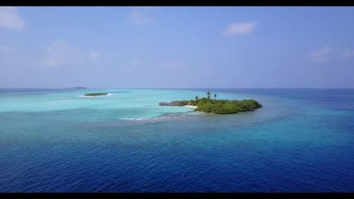 Aerial drone shot scenery of idyllic coastline beach holiday by blue water and white sand background