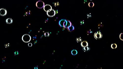 Soap Bubbles Are Flying Fast. Slow Motion. Black Backgrounds