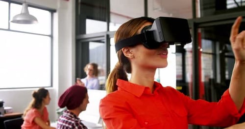 Woman Using VR Headset in Modern Office