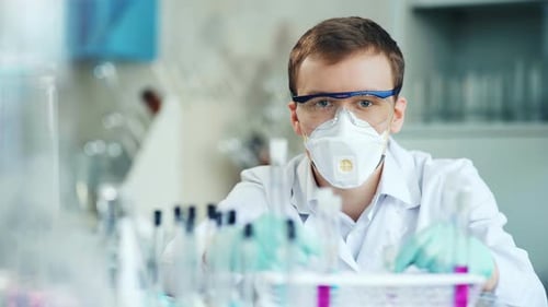 Scientist Works in Lab With Test Tubes