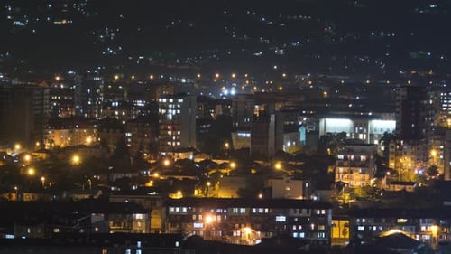 Multistorey Buildings with Changing Window Lighting At Night in City. Timelapse