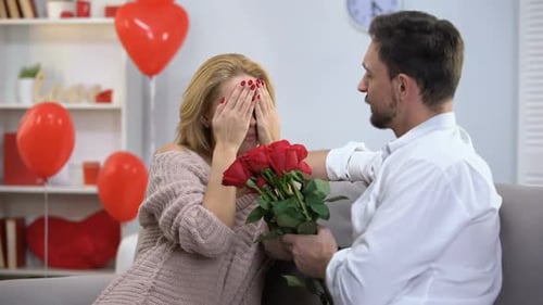Man Gives Red Roses to Happy Woman