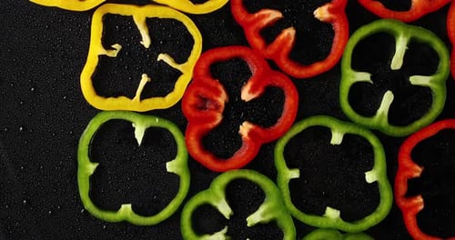 Colorful Sliced Bell Peppers on Black Background