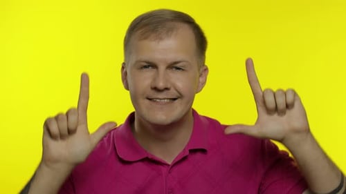 Portrait of Young Caucasian Man Posing in Pink T-shirt. Happy Handsome Guy Celebrates and Dances