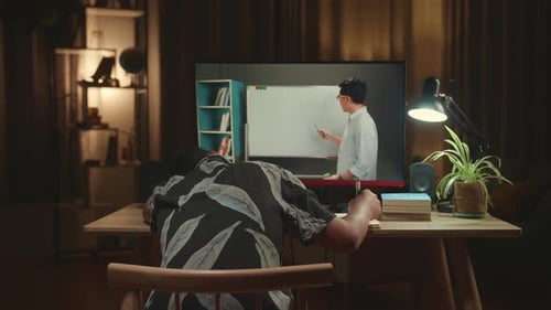 Bored Asian Boy Student Distance Learning With Online Teacher On Computer Screen From Home