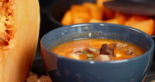 Creamy Pumpkin Soup with Croutons in Bowl