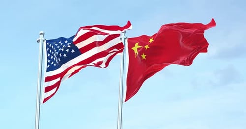 Realistic Waving Flags of USA and China Against Blue Sky