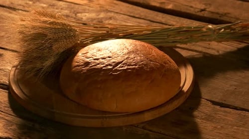 Fresh Bread with Wheat on Wooden Table